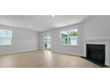 Bright living room features hardwood floors, fireplace, and natural light from large windows at 222 Seele St, Summerville, SC 29485
