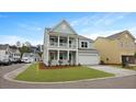 Charming two-story house showcasing a inviting double porch and attached two car garage at 226 Seele St, Summerville, SC 29485