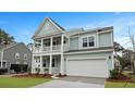 Inviting two-story house showcasing a charming double porch and attached two car garage at 226 Seele St, Summerville, SC 29485