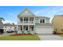 Charming two-story home with a welcoming double porch and a well-maintained front yard at 226 Seele St, Summerville, SC 29485