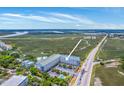Drone shot of Unit 1G showing pool, landscaping, and convenient parking area at 2393 Folly Rd # 1G, Folly Beach, SC 29439