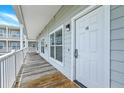 Exterior hallway showing Unit 1G entrance door with electronic lock at 2393 Folly Rd # 1G, Folly Beach, SC 29439