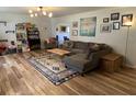Comfortable living room with sectional sofa, wood floors, decorative rug, and ample natural light at 243 Trickle Dr, Summerville, SC 29483