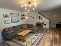 Inviting living room featuring a plush gray sofa, stylish rug, and modern lighting fixture at 243 Trickle Dr, Summerville, SC 29483