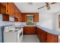 Charming kitchen featuring wooden cabinets, white appliances and window views at 2708 Mawood Ave, North Charleston, SC 29406