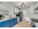 Modern kitchen boasts two-toned cabinets, stainless appliances, quartz countertops, and ample storage at 291 Sea Cloud Cir, Edisto Beach, SC 29438