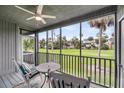 Inviting screened-in porch offers golf course views, seating, ceiling fan, and a calming space to relax at 291 Sea Cloud Cir, Edisto Beach, SC 29438