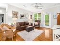 Living room featuring hardwood floors, a leather sofa, an ottoman, and a wicker chair; natural light from outside at 300 Bucksley Ln # 102, Charleston, SC 29492