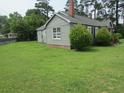 Spacious green lawn surrounding a gray home with lush trees providing shade and privacy at 301 Ridge St, Saint George, SC 29477