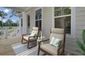 Relaxing porch with seating area, wooden floors, decorative pillows, and calming color scheme at 3027 Robeson Trce, Johns Island, SC 29455