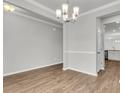 Open dining room with wood floors, a stylish chandelier, and easy access to the kitchen at 322 Abercom Place Dr, Moncks Corner, SC 29461