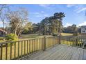 An inviting wood deck overlooking a spacious yard and green trees, perfect for relaxation at 422 Caledon Ct, Johns Island, SC 29455