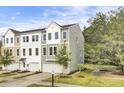 Beautiful townhome with a two-car garage and curb appeal enhanced by manicured landscaping at 422 Caledon Ct, Johns Island, SC 29455