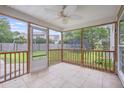Relaxing screened porch featuring tile flooring and open views of the backyard's green space at 5289 Mulholland Dr, Summerville, SC 29485