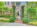 Ornate iron gate with brick columns covered in vines leading to the front of the house at 62 Eastlake Rd, Mount Pleasant, SC 29464