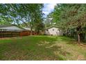 Backyard featuring green lawn and some shady trees providing a peaceful outdoor space at 638 Cashew St, Charleston, SC 29407