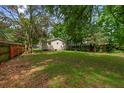A spacious backyard with grass and mature trees, providing ample space for outdoor activities at 638 Cashew St, Charleston, SC 29407