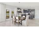Light-filled dining area with modern light fixture, open to kitchen, and offering outdoor access at 724 Meadowbrook Ln, Summerville, SC 29486