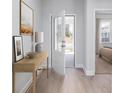 Inviting entryway with light wood floors, leading into a bedroom with an open door and natural light at 778 Meadowbrook Ln, Summerville, SC 29486