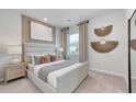 Relaxing bedroom with a plush upholstered headboard, neutral color scheme, decorative wall art, and natural light at 782 Meadowbrook Ln, Summerville, SC 29486