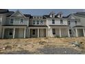 Newly built townhomes showcase varied exterior colors and inviting covered front entries at 821 Alma Square Dr, Moncks Corner, SC 29461