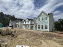 New townhomes with modern farmhouse design feature inviting exteriors with light colors and well-manicured surroundings at 823 Alma Square Dr, Moncks Corner, SC 29461