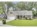Attractive single-Gathering home with lush green lawn, attached garage, and curb appeal at 8612 Hickory Creek Ln, North Charleston, SC 29420