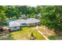 An aerial view of the home shows a stone path, manicured lawn and a wooded surrounding at 881 Evans Rd, Charleston, SC 29412