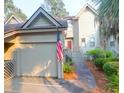 Charming two-story home featuring a garage, front entrance, and American flag in a quaint neighborhood at 1050 Marsh Court Ln, Mount Pleasant, SC 29464