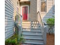 Inviting front entrance with a bright red door, white steps, and manicured landscaping at 1050 Marsh Court Ln, Mount Pleasant, SC 29464