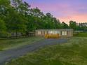 Inviting home exterior with a cozy front porch and a long, paved driveway at 106 Swanson Dr, Summerville, SC 29483