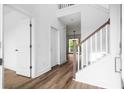Bright entryway featuring hardwood floors, white walls, and wooden staircase at 1076 Williams Rd, Charleston, SC 29412