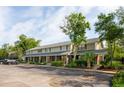 Charming townhome complex featuring brick accents, a covered porch, and ample parking space at 1166 Julian Clark Rd, Charleston, SC 29412