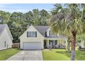 Charming two-story home with green shutters, a well-kept lawn, and a welcoming front porch at 172 Cotillion Cresent Cres, Summerville, SC 29483