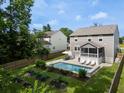 Backyard featuring a swimming pool, an outdoor patio, and raised garden beds in a fenced yard at 1825 Crossbill Trl, Hanahan, SC 29410