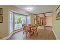 Cozy dining area with a round table, bay window, and wood-look flooring at 202 Hunt Club Dr, Summerville, SC 29485