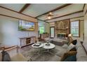 Inviting living room showcasing a brick fireplace, wood-beamed ceiling, and comfortable furnishings at 202 Hunt Club Dr, Summerville, SC 29485