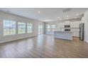 Open-concept living area with hardwood floors, recessed lighting, and stainless steel appliances at 206 Camellia Bloom Dr, Moncks Corner, SC 29461