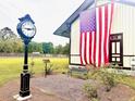 Town clock and American flag outside historic Ravenel building at 2140 Macallan Blvd, Ravenel, SC 29470