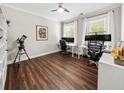 Home office space with dark wood floors, white trim, a shelving unit, and two windows at 2152 Pentland Dr, Charleston, SC 29412