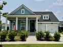 Charming home featuring blue siding, white trim, inviting front porch and a well-manicured front yard at 2221 Generals St, Charleston, SC 29492