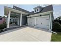 Spacious two-car garage featuring white doors with black hardware, complemented by a well-maintained driveway at 2221 Generals St, Charleston, SC 29492