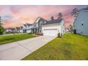 Beautiful home with a long driveway, well-kept lawn, and appealing architectural design in a friendly neighborhood at 223 Granton Edge Ln, Summerville, SC 29486