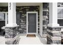 Inviting front porch with stone accents, a stylish front door, and a welcoming entrance to the home at 223 Granton Edge Ln, Summerville, SC 29486
