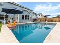 Backyard view of pool with patio furniture and well-maintained lawn at 256 Fiddleback Dr, Summerville, SC 29486