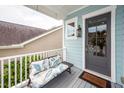 Front porch of the light blue home features a Welcome mat and comfortable seating for relaxing outdoors at 2734 Battle Trail Dr, Johns Island, SC 29455