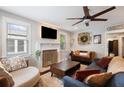 A comfy living room with a ceiling fan, decorative fireplace, and lots of seating for relaxing or entertaining at 2924 Alabama Dr, North Charleston, SC 29405