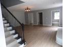 Open-concept living area featuring hardwood floors, stairs, and neutral paint at 301 Archibald Dr, Goose Creek, SC 29445