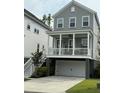 Charming two-story home with a covered porch, gray siding, white trim and a two car garage at 3016 Evening Tide Dr, Hanahan, SC 29410