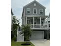 Charming two-story home with a covered porch, gray siding, white trim and a two car garage at 3016 Evening Tide Dr, Hanahan, SC 29410